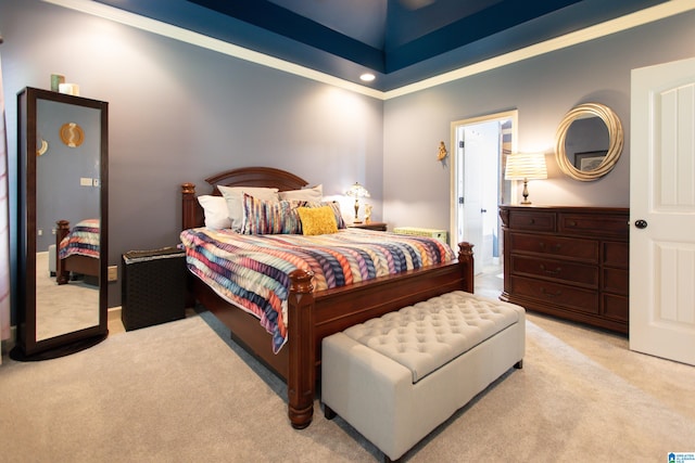 bedroom with ornamental molding and light colored carpet