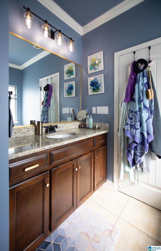 bathroom with crown molding, tile patterned flooring, and vanity