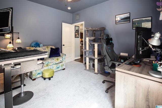 carpeted home office with ceiling fan