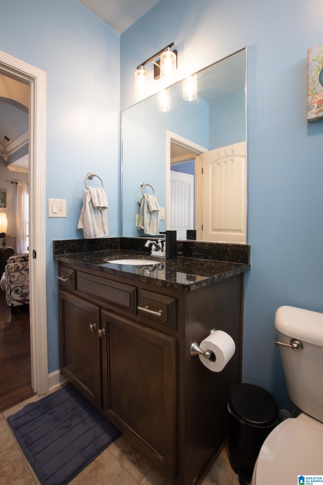 bathroom with vanity, hardwood / wood-style floors, and toilet