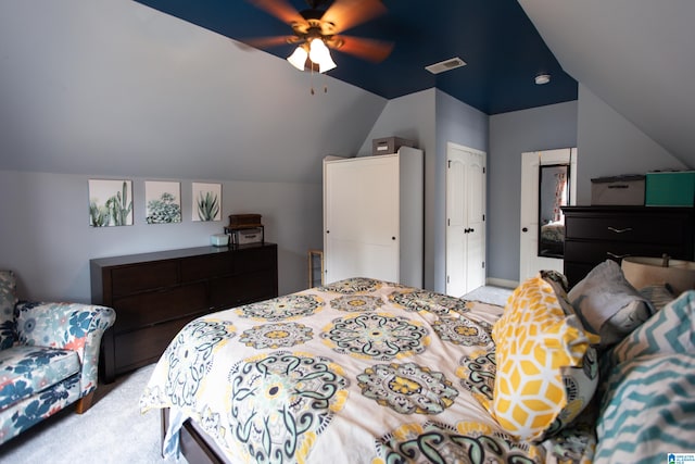 bedroom featuring light carpet, a closet, vaulted ceiling, and ceiling fan