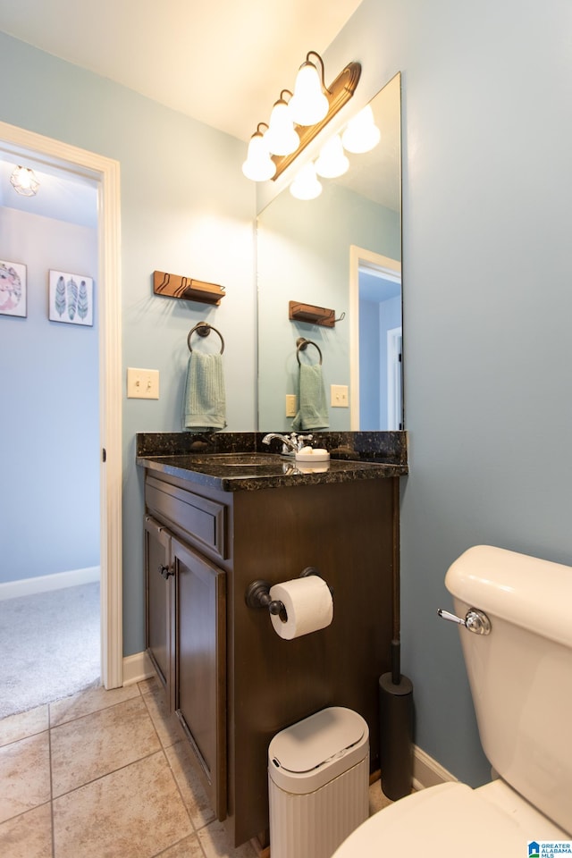 bathroom with tile patterned floors, vanity, and toilet