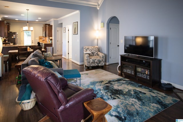 living room with dark hardwood / wood-style floors and crown molding