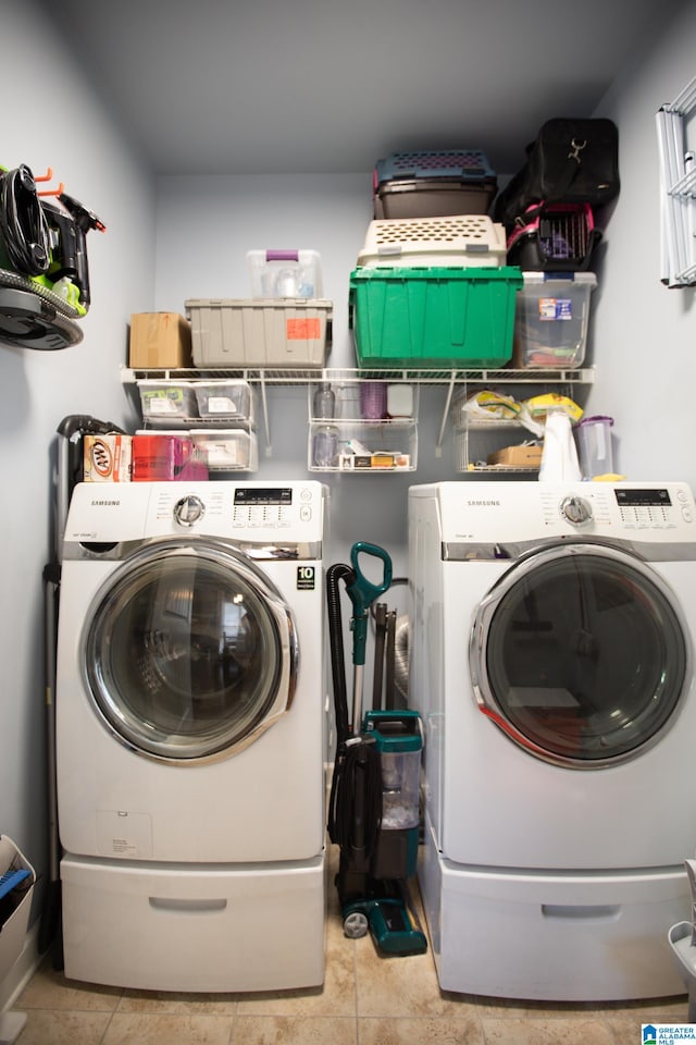 laundry room with separate washer and dryer and light tile patterned flooring