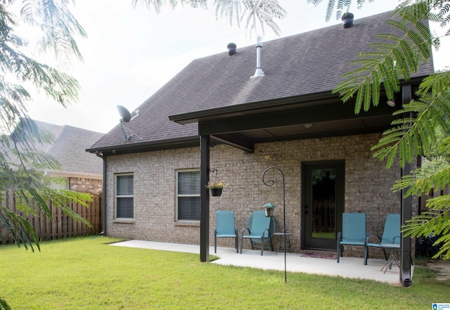 back of house with a yard and a patio area