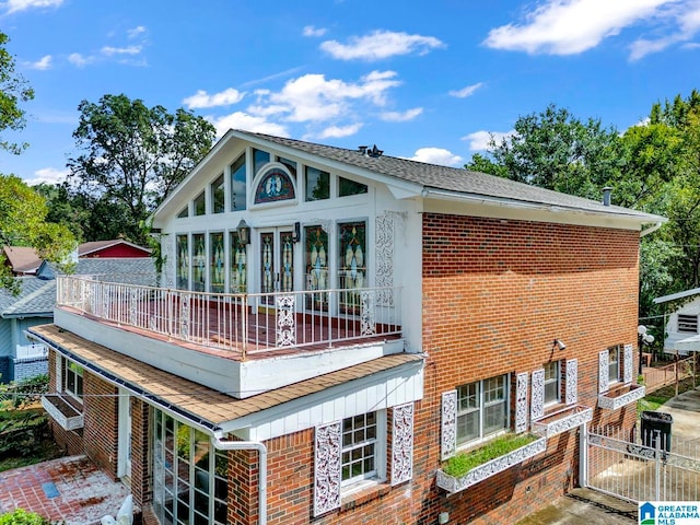 back of property featuring a balcony