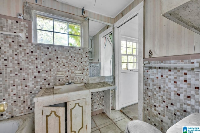 bathroom with vanity, tile walls, and toilet