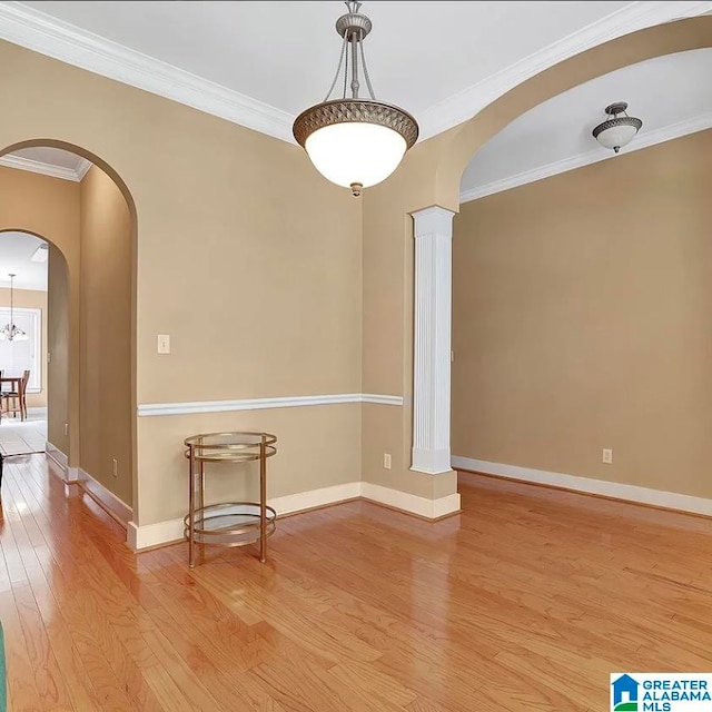 unfurnished room featuring ornamental molding and light hardwood / wood-style floors