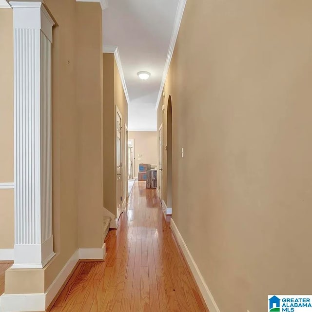 hall featuring light wood-type flooring and ornamental molding