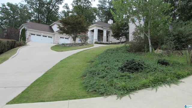 view of front of house with a garage and a front lawn