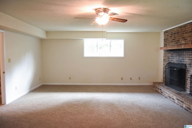 unfurnished living room with a brick fireplace, ceiling fan, and carpet flooring