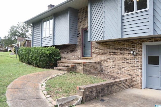 view of side of property with a garage and a lawn