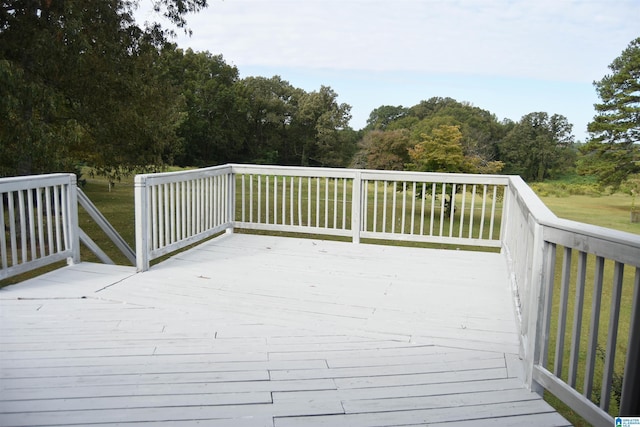 wooden terrace with a lawn