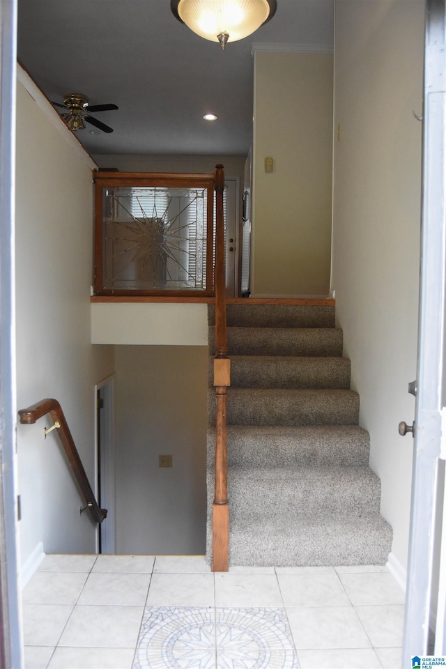 stairway featuring ceiling fan and tile patterned floors