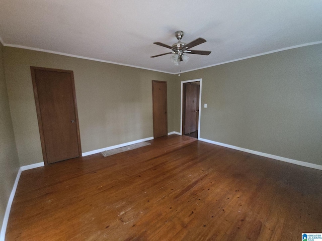 spare room featuring baseboards, ceiling fan, ornamental molding, and wood-type flooring