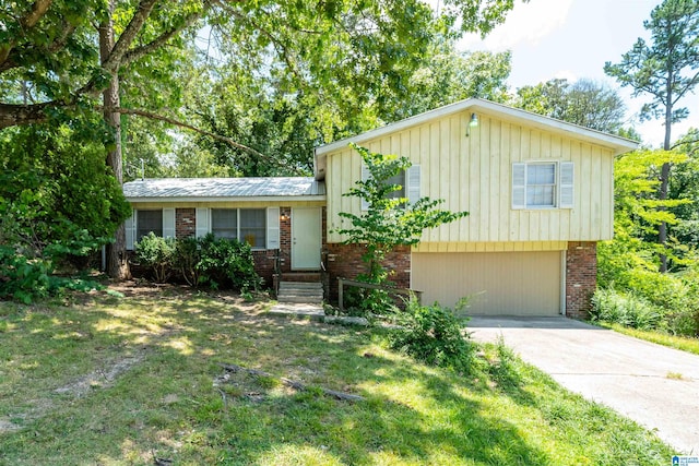 split level home featuring a front yard and a garage