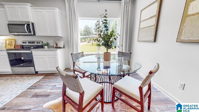 dining space featuring light wood-type flooring