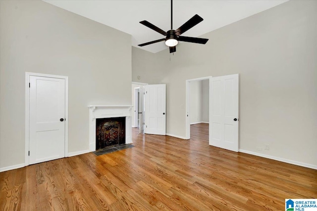 unfurnished living room with ceiling fan, light hardwood / wood-style flooring, and high vaulted ceiling