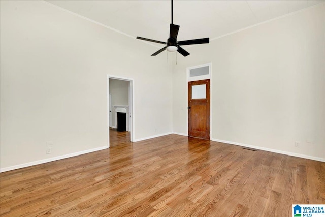 empty room with light hardwood / wood-style floors and ceiling fan