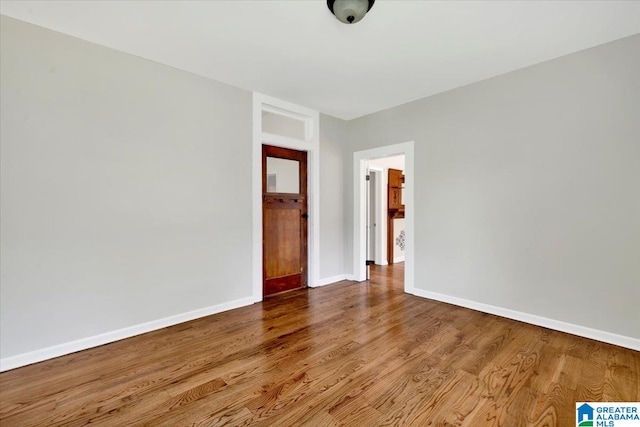 spare room with wood-type flooring