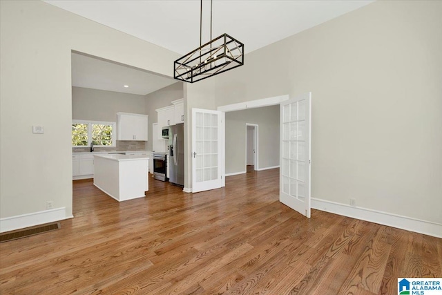 unfurnished dining area featuring light hardwood / wood-style floors and french doors