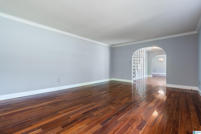 spare room featuring ornamental molding, a textured ceiling, and dark wood-type flooring