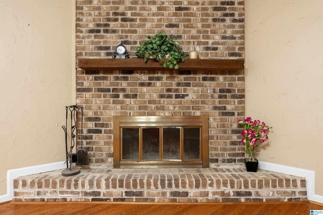 details featuring hardwood / wood-style floors and a fireplace