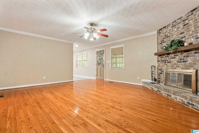 unfurnished living room featuring a textured wall, a textured ceiling, and ceiling fan