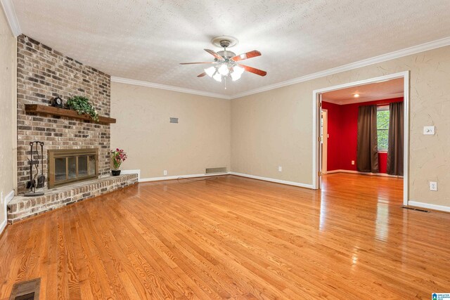 unfurnished living room with visible vents, ceiling fan, wood finished floors, and a textured ceiling