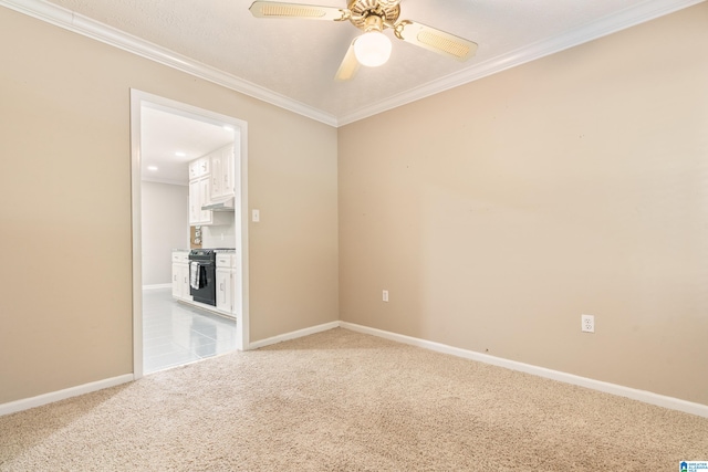 carpeted spare room with crown molding and ceiling fan