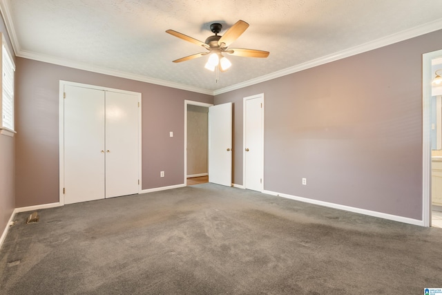 unfurnished bedroom with ceiling fan, crown molding, carpet flooring, and ensuite bathroom