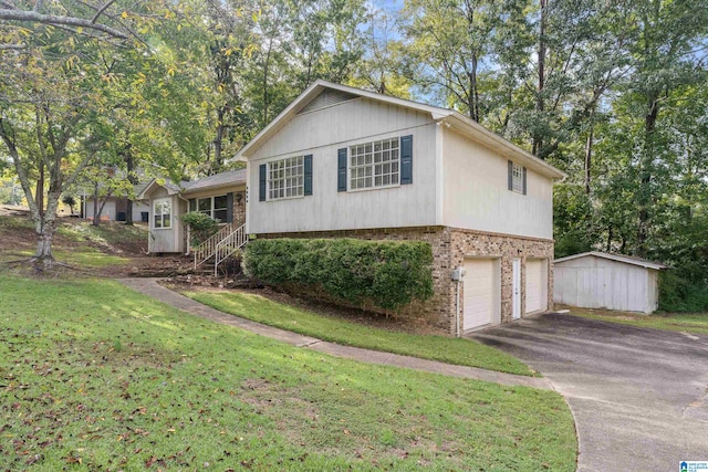 split level home featuring a front yard, a shed, and a garage