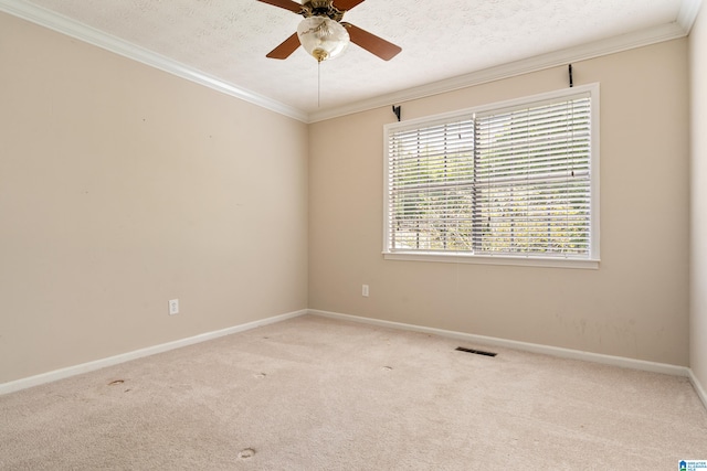 carpeted empty room featuring crown molding, a textured ceiling, and ceiling fan