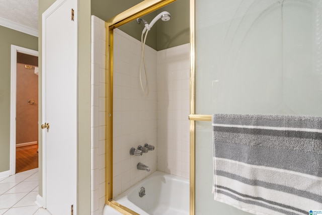 bathroom with ornamental molding, tiled shower / bath combo, a textured ceiling, and tile patterned flooring