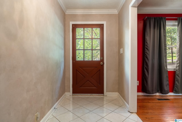 entryway featuring ornamental molding and light wood-type flooring