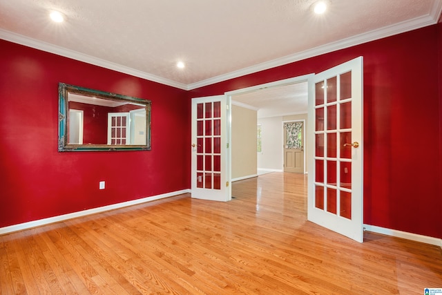 unfurnished room with french doors, ornamental molding, and hardwood / wood-style flooring