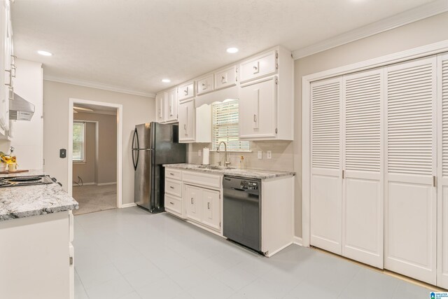 kitchen with tasteful backsplash, ornamental molding, white cabinetry, black appliances, and a sink