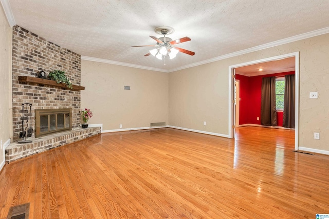 unfurnished living room with a fireplace, a textured ceiling, light hardwood / wood-style floors, and ceiling fan