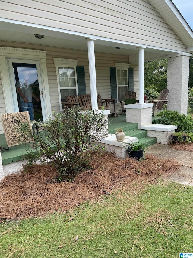 view of exterior entry with a porch