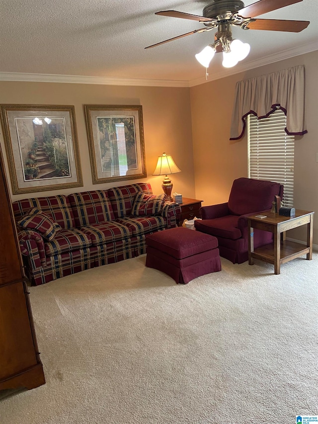 living room featuring a textured ceiling, carpet flooring, ornamental molding, and ceiling fan