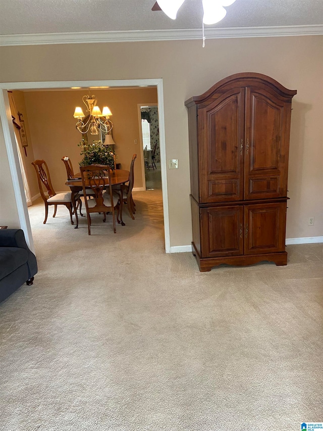 dining space with a textured ceiling, ceiling fan with notable chandelier, crown molding, and light colored carpet