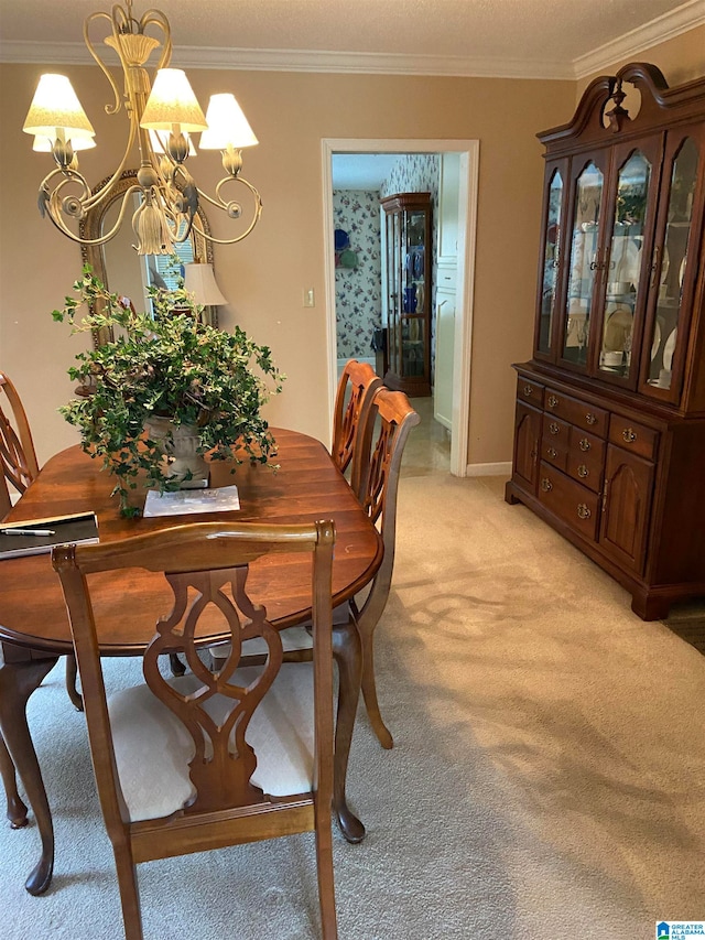 dining room with ornamental molding, light colored carpet, and a chandelier