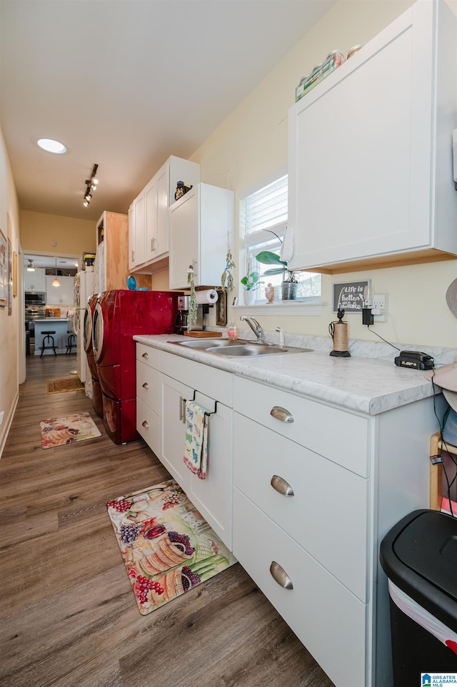 kitchen with white cabinetry, sink, and dark wood-type flooring