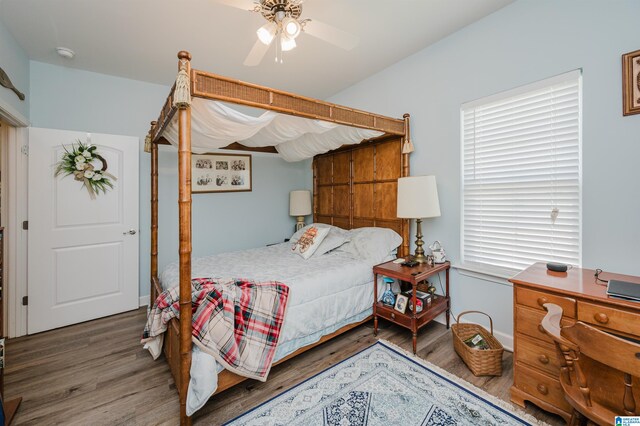 bedroom with ceiling fan and dark wood-type flooring