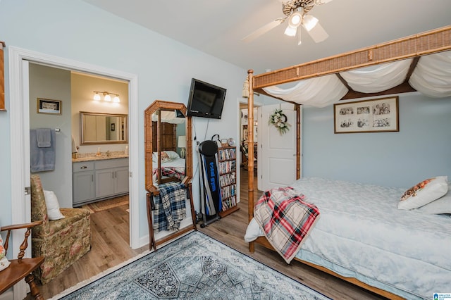 bedroom with light wood-type flooring, ensuite bath, and ceiling fan