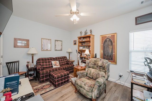 living room featuring ceiling fan and light hardwood / wood-style floors