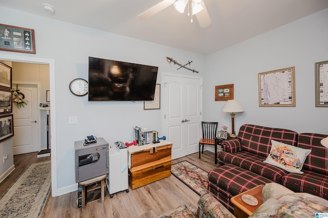 living room featuring ceiling fan and hardwood / wood-style floors