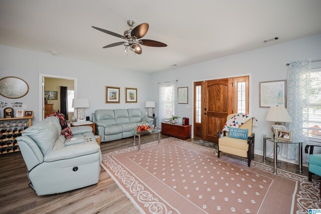 living room with ceiling fan and hardwood / wood-style flooring