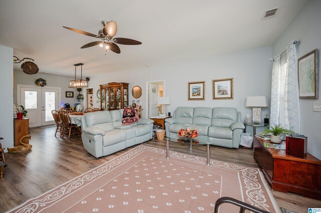 living room with ceiling fan, french doors, and hardwood / wood-style flooring