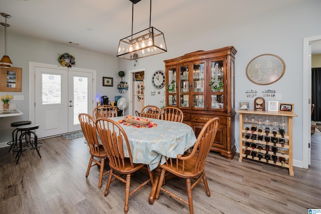 dining room with a chandelier and light hardwood / wood-style floors